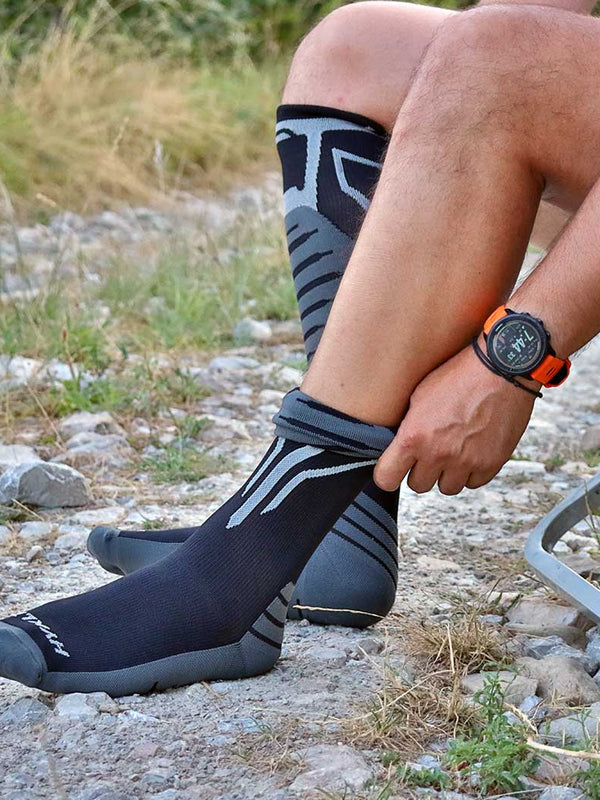 Pulling on a HYKLE compression sock outdoors