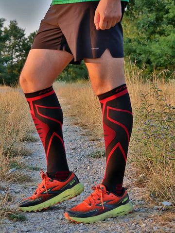 Runner in HYKLE compression socks on a dirt trail